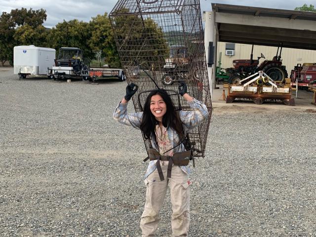 Lina Vu carrying large trap