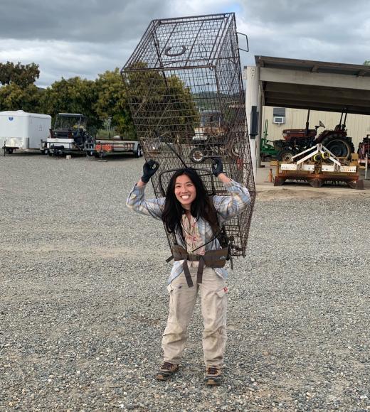 Lina Vu carrying large trap