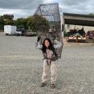 Lina Vu carrying large trap